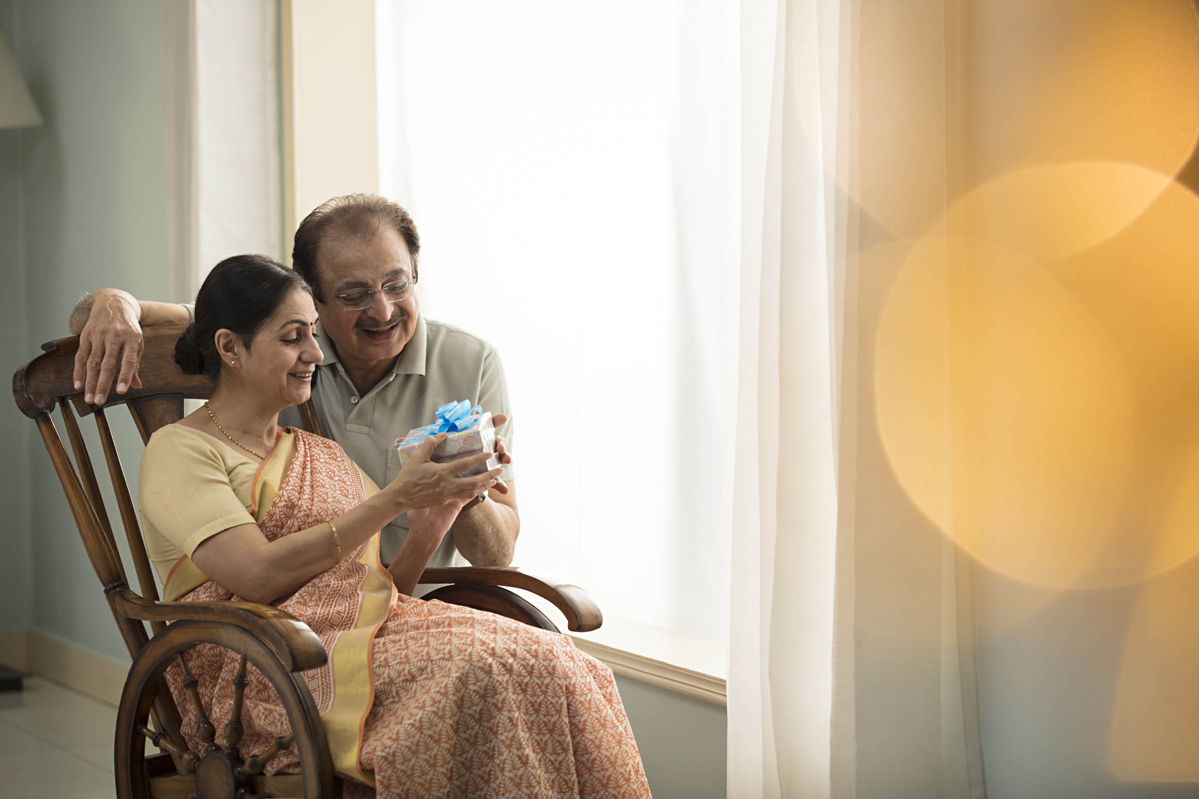Caregiver warmly assisting senior resident