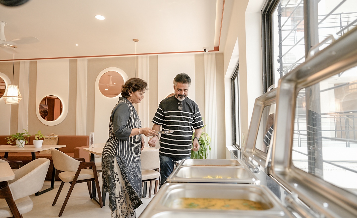 Community dining hall with residents